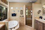 Jacuzzi tub and walk in shower and separate toilet area